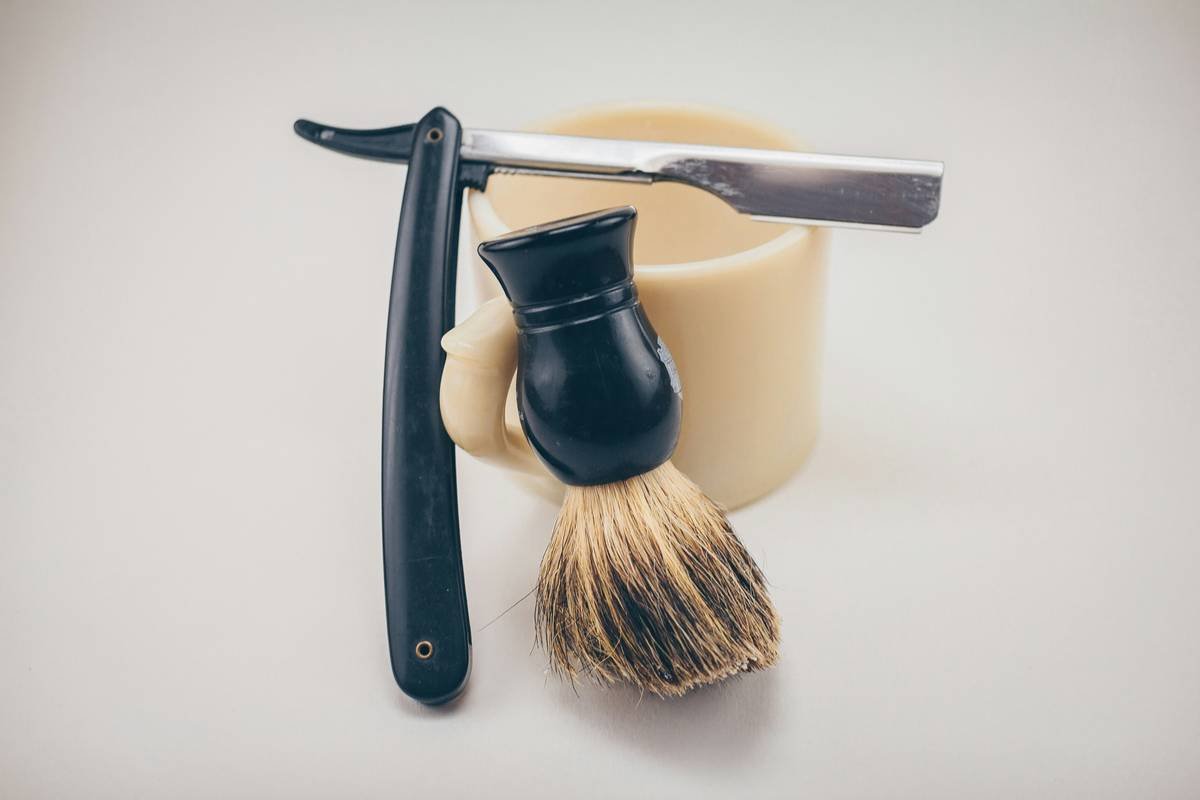 Side-by-side comparison of lather texture from traditional shaving soap vs cream showing soap's denser, drier foam versus cream's airy, moist bubbles